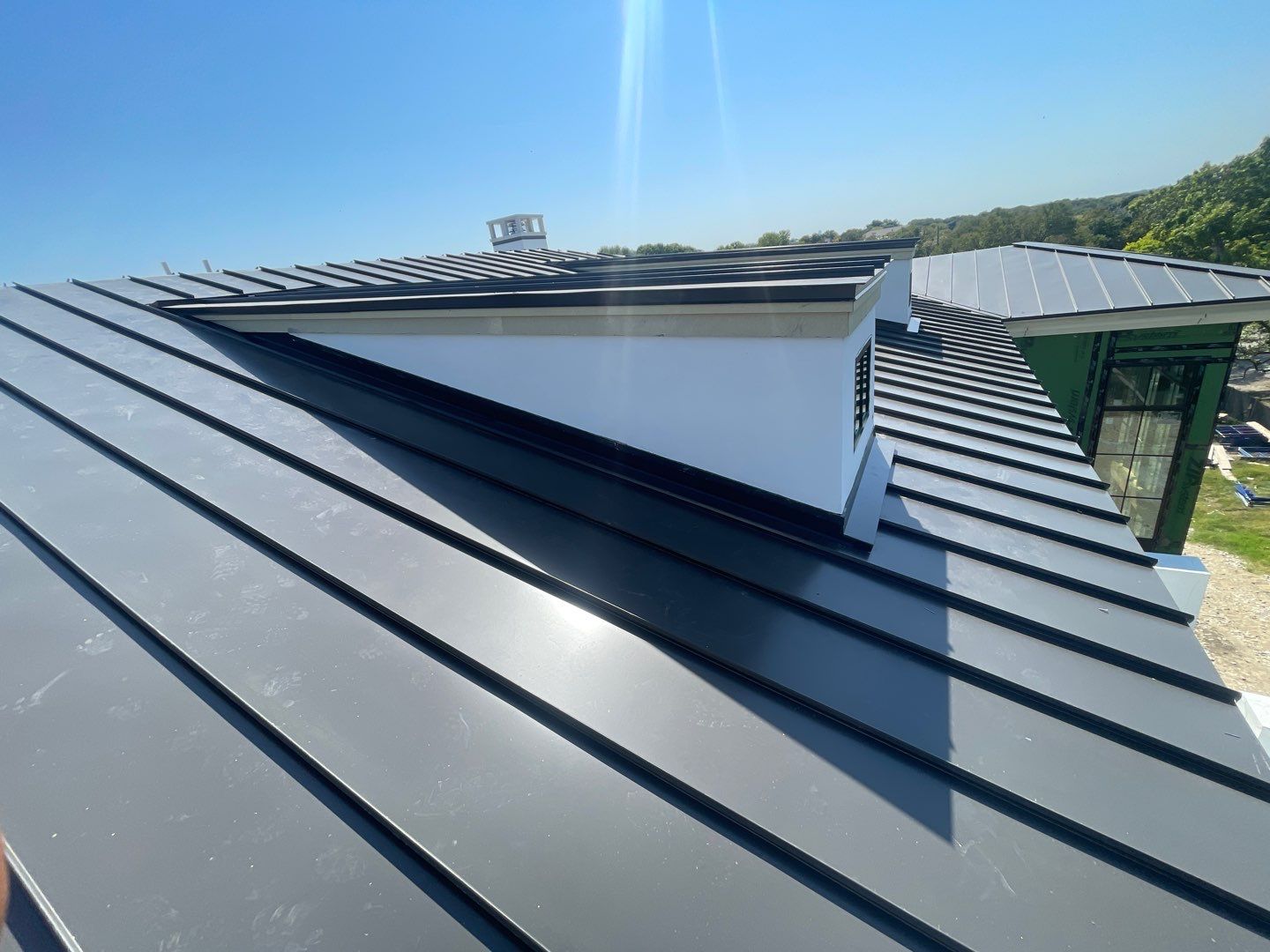 Standing seam panels at the dormer