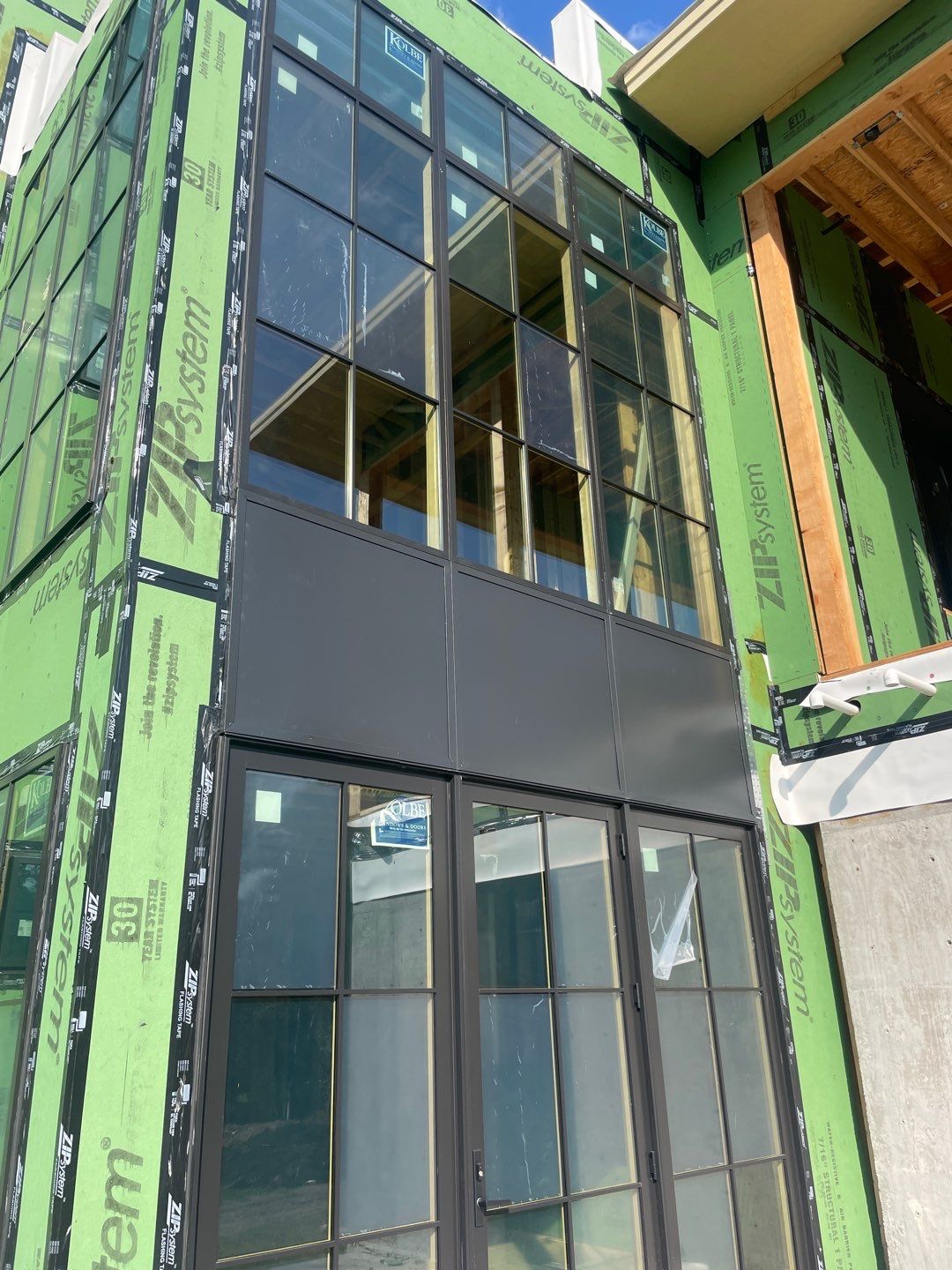 Metal wall panels between window walls